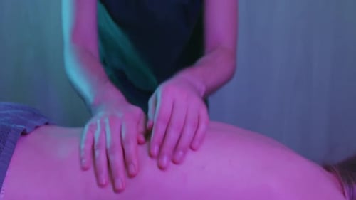 Massage in der Klinik Ein Männertherapeut massiert den nackten Rücken