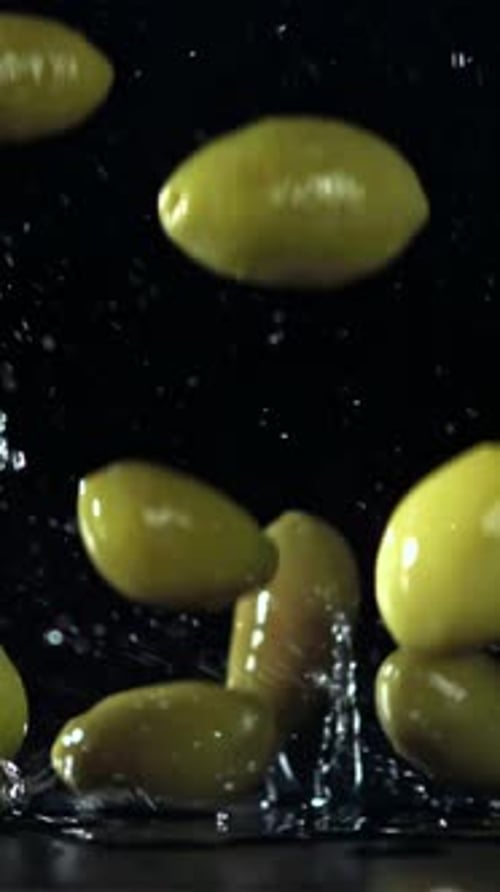 The Olives Fall on the Table with Splashes Filmed on a Highspeed Camera at 1000 Fps