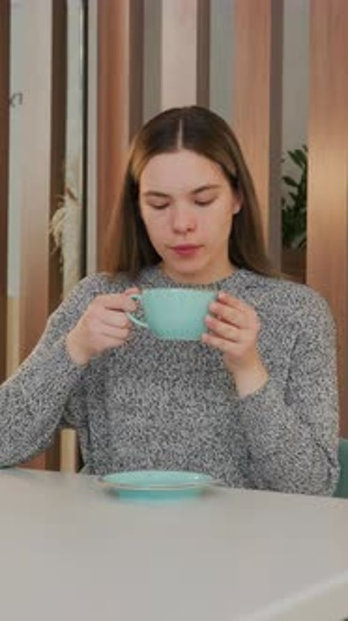 Female Student Peacefully Sipping Coffee in Cozy Cafe Environment Calm Young Woman Leisurely