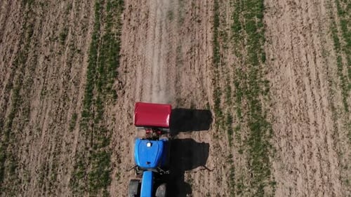 Tractor Working in Farm Fields Aerial View