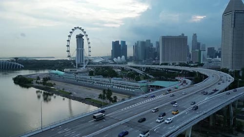 Drone shot flying above ECP Bridge towards Marina Promenade and Singapore Flyer Eye, tracking of For