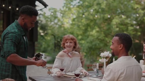 Friends Sharing Wine at Outdoor Table