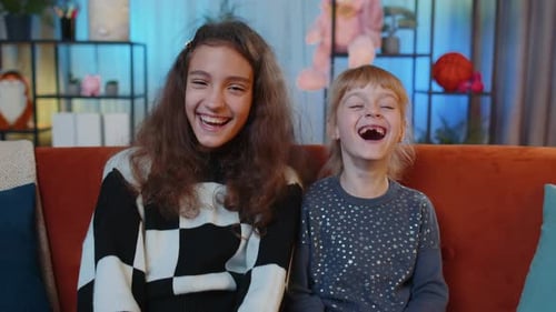 Happy Girls Smiling and Laughing Together Indoors