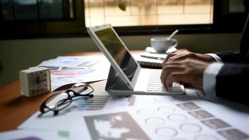 Hands Typing on Tablet Keyboard in Workplace
