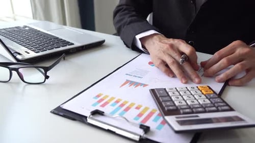 Businessman working on Desk office with marketing graph statistics analysis