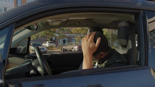 Angry African American Driver Hitting Steering Wheel with Fists During Drive