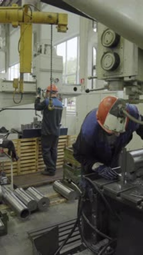 Metal Industry Workers Operating a Hydraulic Press in a Factory Stock Clip