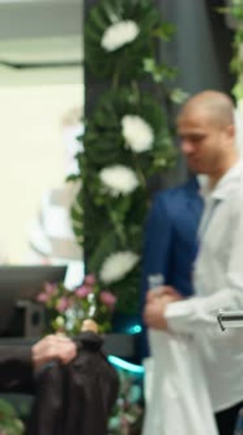 Vertical Video Designer Boutique Assistant Arranging a Vibrant Selection of Garments on Racks