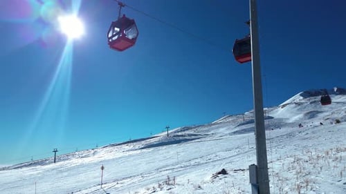 Gondolas carrying skiers to the top