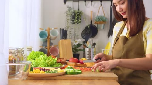 Woman Preparing Healthy Salad in Bright Kitchen