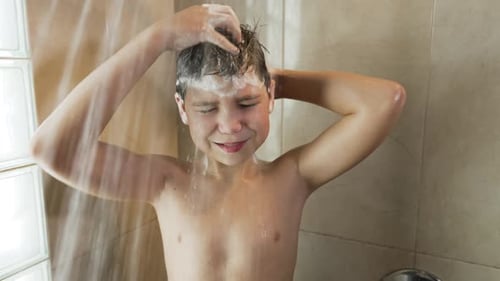 Teen Boy Washing Hair in Bathroom Shower