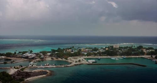 Aerial view of a scenic landscape of island with tourist luxury resort with white sand beach, crys
