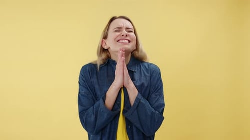 Hopeful Woman Clasping Hands and Crossing Fingers