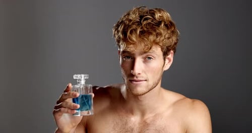 Face, cologne and man in studio, cosmetics and dermatology treatment on gray background