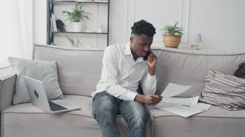Young Adult On Couch Talking on Phone