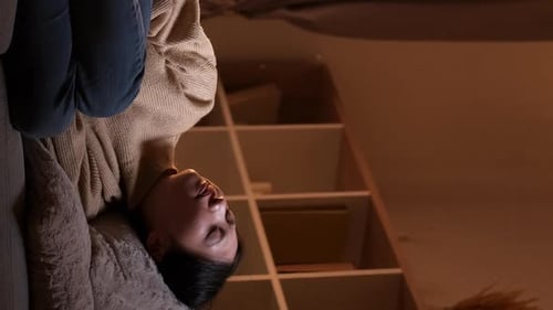 Young Woman Relaxes on Couch at Home
