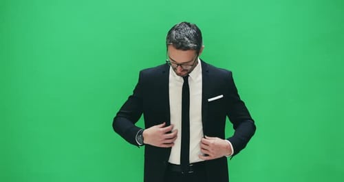 4k video footage of a businessman posing against a green background
