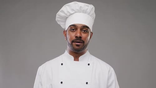 Male Chef Talking and Gesturing in Kitchen Studio