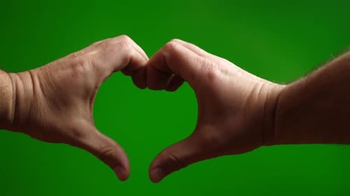 40a. With both hands, make the image of a heart on a green background.