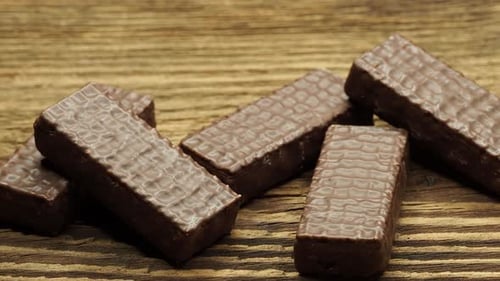 Chocolate wafer snacks on a wooden surface