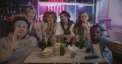 Friends Watch Tense Game Together in Living Room