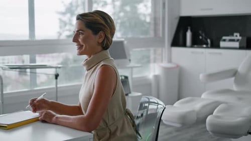 Smiling middle aged woman discussing antiaging skincare at a beauty clinic