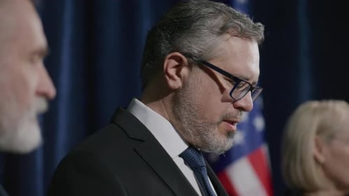 Suited Professionals at a Formal Press Conference