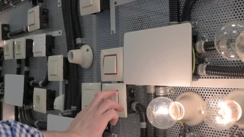 Hand Switching Light Switches On and Off