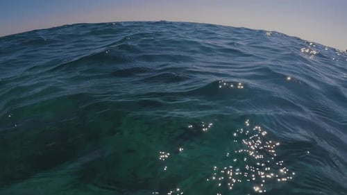 Surface of water with curved horizon line, Low-angle shot, seascape. Small waves on sea surface