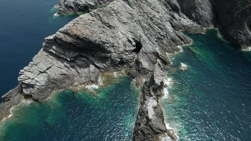 (Top down view) Aerial view fly over drone over sea cliff with powerful sea waves. Beach sand in Sar