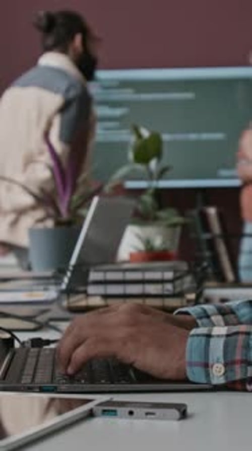 Hands of Anonymous Programmer Typing Code on Laptop at Work