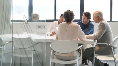 Group of colleagues meeting in modern office