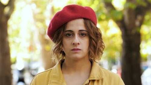 Young Adult Woman Wearing Beret Looking at Camera