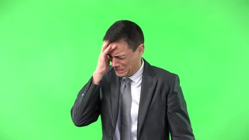 Crying Man in Formal Suit Against Chroma Key