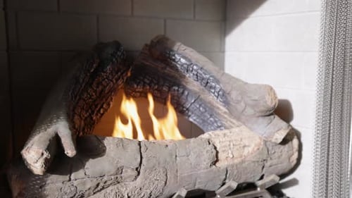 Warm cozy burning fire in a brick fireplace, close-up shot.