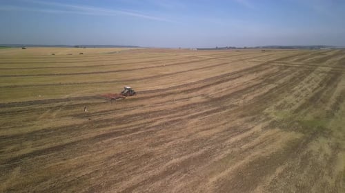 Tractor working on the field doing tillage with cultivator
