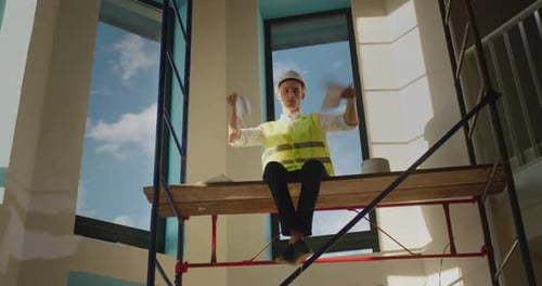 The Evil Builder Tears Up the Documents and Clwheres Down Sits High on the Scaffolding