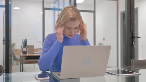 Young Adult Woman Working on Laptop at Desk