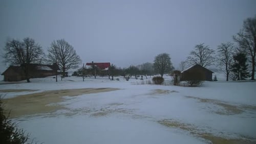 Winter passage with wooden cabins and snowy terrain. Timelapse shot.
