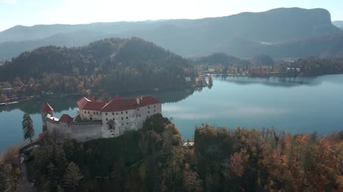 incredible pan view of lake bled castle and lake bled in the background early in the morning during