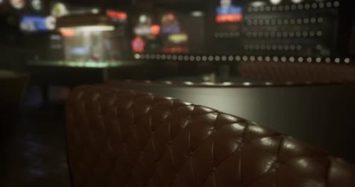 Cozy Leather Seating in a Lively Bar During Late Evening Hours
