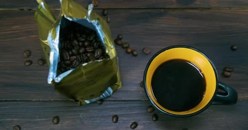 Coffee Beans and Dark Brew on Wooden Table