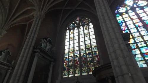 Ornate Gothic architecture inside Saint Bavo's Cathedral in Ghent, Belgium, showcasing stained glass