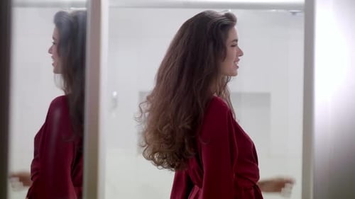 Attractive Brunette Woman Turns and Smiles at Mirror