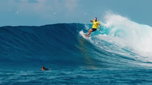 Professional Surfer Rides Big Ocean Wave in the Maldives