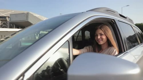 Smiling Brunette Woman Sitting in Car