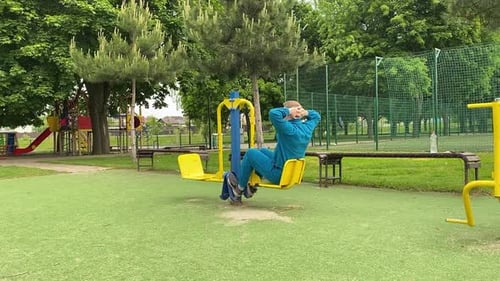 A male athlete works out at the outdoor gym
