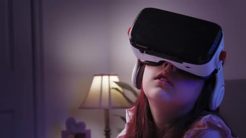 Girl Using Virtual Reality Headset in Dimly Lit Room