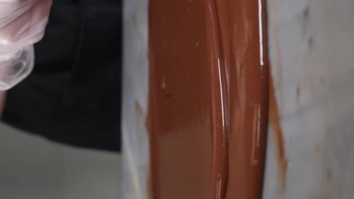 Tempering Chocolate Vertical Footage Chef Mixes Melted Chocolate in Pastry Shop Craft Sweets Candies