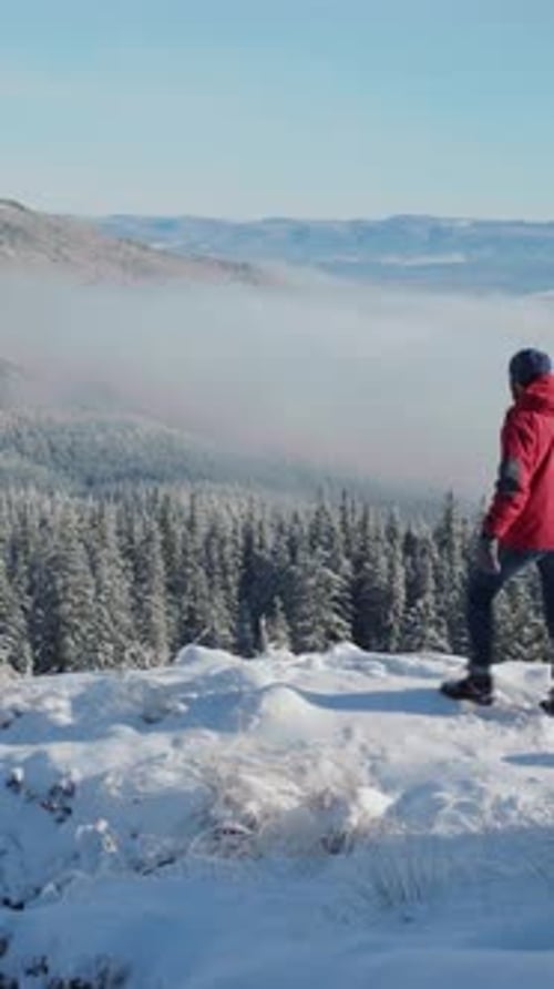 Happy Young Traveler Man Standing on Mountain Peak Spreading Arms Enjoying Fresh Air and Freedom